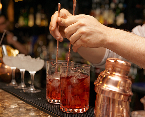 Bartender mixing drinks during a bar stroll